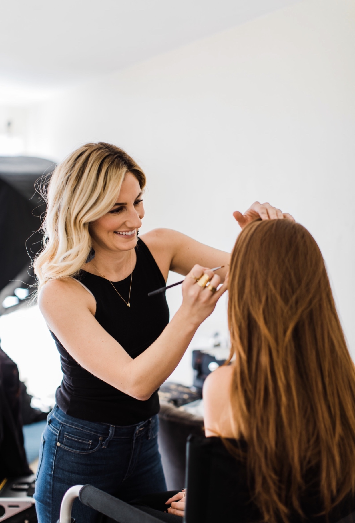 Emily Barton, hair and makeup artist, does makeup for a bride.